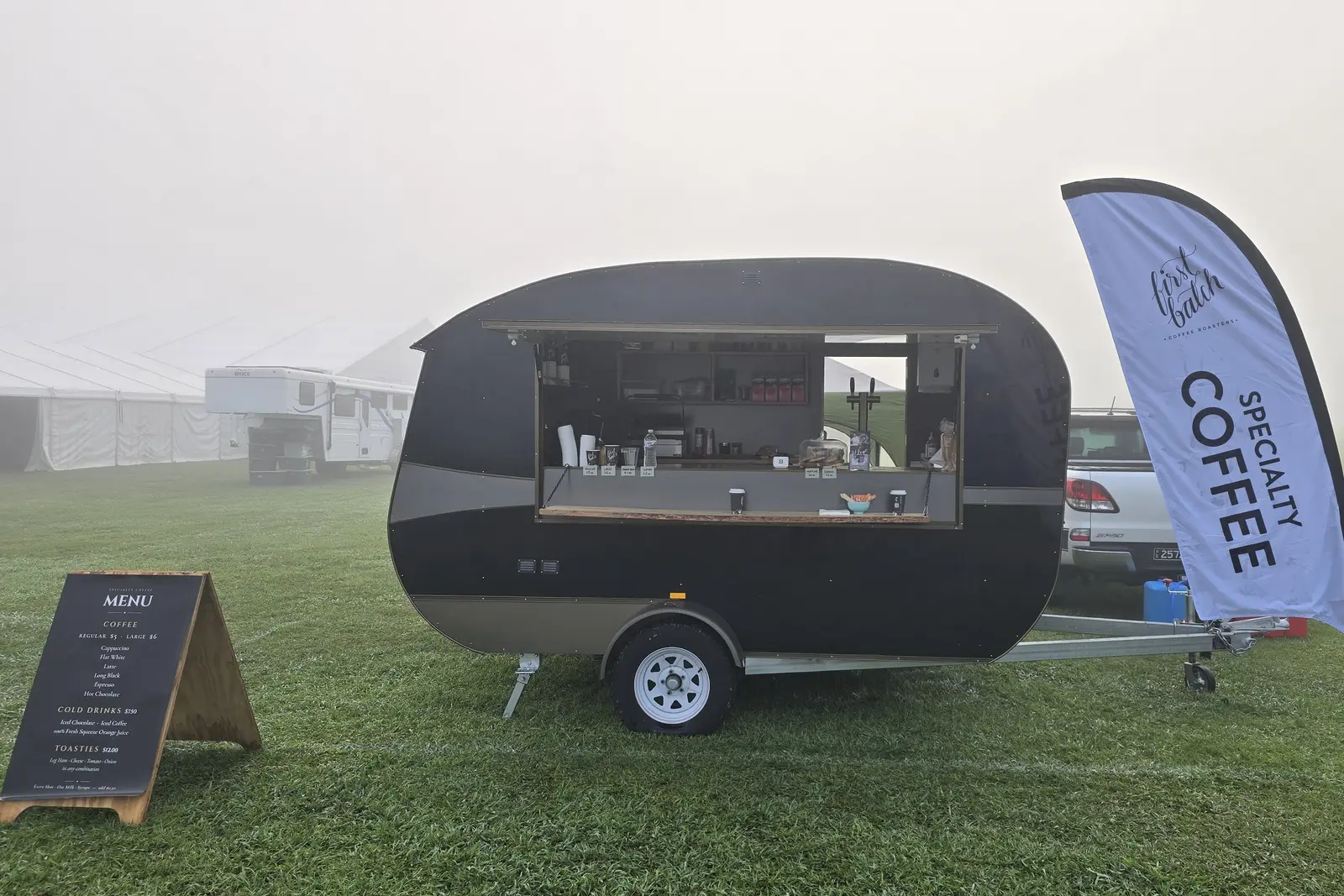 Mobile coffee van set up on a foggy morning at a country event