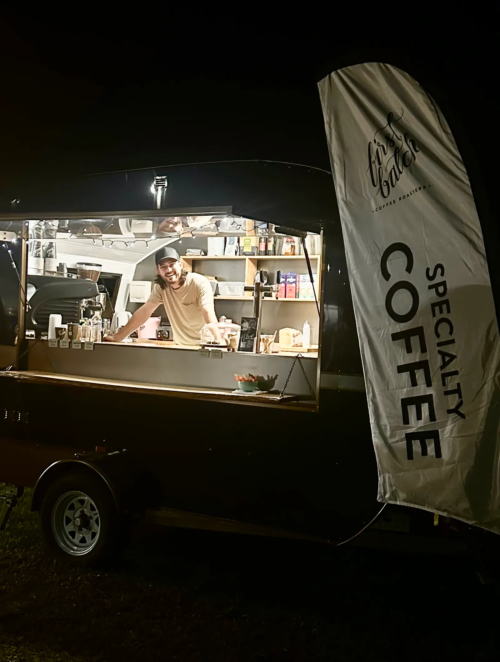 Mobile coffee van lit up at night serving an early start